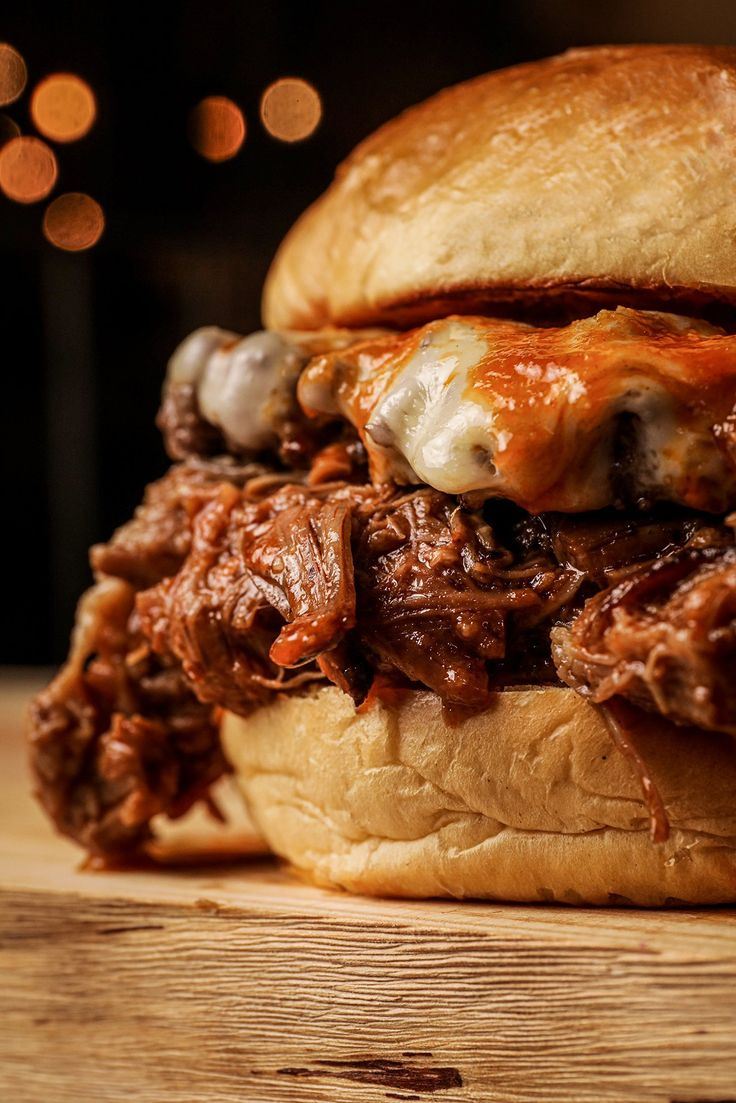 Burger de costela desfiada com molho barbecue e queijo gratinado em pão macio